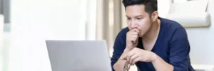 homem olhando concentrado para computador